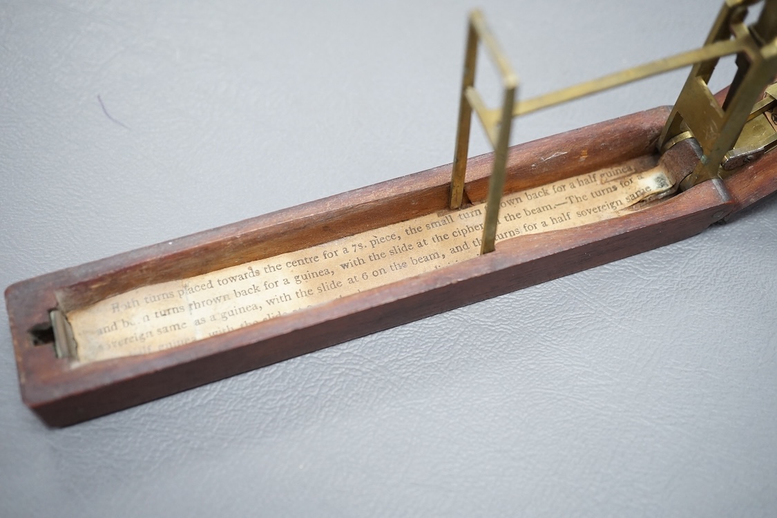 A set of 19th century brass and mahogany folding sovereign scales, 14cm long.